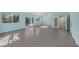 Spacious Gathering room, featuring tile flooring and access to the backyard at 7108 Riverwood Blvd, Tampa, FL 33615