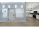 Modern kitchen with white cabinets, stainless steel appliances and a tiled backsplash at 7108 Riverwood Blvd, Tampa, FL 33615