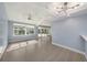 Open concept living area with high ceilings and light gray tile flooring at 7108 Riverwood Blvd, Tampa, FL 33615