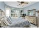 Relaxing main bedroom features wood-style floors, bay windows, and a ceiling fan at 7815 Blue Spring Dr, Land O Lakes, FL 34637