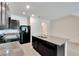 Modern kitchen island with granite countertop and double sink at 8751 Falling Blue Pl, Riverview, FL 33578