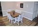 Bright dining area featuring a wood table and white chairs at 915 Rolling Hills Dr, Palm Harbor, FL 34683