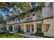 Front view of charming townhouses with balconies and lush landscaping at 946 Highland Ave # 65, Dunedin, FL 34698