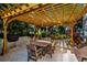 Outdoor patio with pergola, grill, table, and chairs, ideal for entertaining at 946 Highland Ave # 65, Dunedin, FL 34698