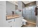 Modern bathroom with granite countertop, white cabinets, and a glass shower door at 959 Melrose S Ave, St Petersburg, FL 33705