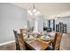 Bright dining room with a wooden table, seating for six, and view into the living room at 959 Melrose S Ave, St Petersburg, FL 33705