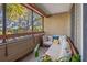 Relaxing screened balcony offering outdoor seating and treetop views at 10263 Gandy N Blvd # 202, St Petersburg, FL 33702