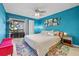 Bright bedroom with a king-size bed and teal accent wall at 10263 Gandy N Blvd # 202, St Petersburg, FL 33702