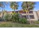 Condo building exterior with lush landscaping and palm trees at 10263 Gandy N Blvd # 202, St Petersburg, FL 33702