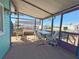 Relaxing screened porch with table and chairs, overlooking the water at 110 W Saint Annes Cir, Apollo Beach, FL 33572