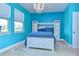 Bedroom with a unique blue wall and a built-in shelving unit at 11807 Cross Vine Dr, Riverview, FL 33579