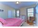 Bright bedroom with a comfortable bed and rocking chair at 11807 Cross Vine Dr, Riverview, FL 33579