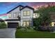 Two-story home with a dark brown garage door and landscaped lawn at 11807 Cross Vine Dr, Riverview, FL 33579