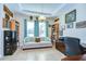 Bright home office with a comfortable couch and built-in shelves at 11807 Cross Vine Dr, Riverview, FL 33579