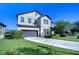 Two-story house with a large driveway and landscaped yard at 11807 Cross Vine Dr, Riverview, FL 33579