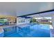 Covered patio with pool, spa and outdoor kitchen area at 11807 Cross Vine Dr, Riverview, FL 33579