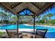 Relaxing pool area with tiki huts and lounge chairs at 11807 Cross Vine Dr, Riverview, FL 33579