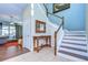 Elegant staircase with wood railing and ornate console table at 11807 Cross Vine Dr, Riverview, FL 33579