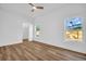 Bright bedroom with ceiling fan and wood-look flooring at 1437 Hounds Hollow Ct, Lutz, FL 33549