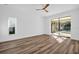 Bright bedroom with hardwood floors and sliding glass doors leading to the pool at 1437 Hounds Hollow Ct, Lutz, FL 33549