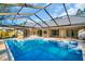 Large screened pool with adjacent spa and spacious patio at 1437 Hounds Hollow Ct, Lutz, FL 33549