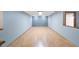 Spacious basement area with light wood laminate flooring at 16124 Vanderbilt Dr, Odessa, FL 33556