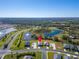 Aerial view of a house nestled in a community by a lake, roads, and conservation at 16207 59Th E Ct, Parrish, FL 34219