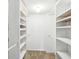 Walk-in closet with white shelves and hanging rods at 1847 Shore S Dr # 509, South Pasadena, FL 33707