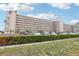Exterior view of condo building, showcasing multiple floors, balconies, landscaping and parking area at 1847 Shore S Dr # 509, South Pasadena, FL 33707