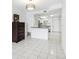Bright kitchen with white cabinets, tile floors, and an open layout connecting to dining area at 1847 Shore S Dr # 509, South Pasadena, FL 33707