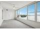 Bright living room with carpet floors and large window offering a water view at 1847 Shore S Dr # 509, South Pasadena, FL 33707