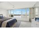 Main bedroom with carpet floors and large window offering a water view at 1847 Shore S Dr # 509, South Pasadena, FL 33707