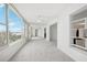 Bright sunroom with large windows offering a beautiful waterfront view, and mirrored wall at 1847 Shore S Dr # 509, South Pasadena, FL 33707