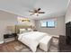 Virtually staged bedroom with neutral walls, wood floors, and large window at 19029 Us Highway 19 N # 32F, Clearwater, FL 33764