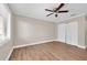 Empty bedroom featuring wood-look flooring, neutral walls, ceiling fan, and closet at 19029 Us Highway 19 N # 32F, Clearwater, FL 33764