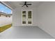 Covered back patio with double doors leading to backyard at 200 W Kirby St, Tampa, FL 33604