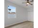Spacious bedroom with hardwood floors, ceiling fan, and large window at 200 W Kirby St, Tampa, FL 33604
