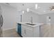 Modern kitchen island with double sink, blue dishwasher, and pendant lighting at 200 W Kirby St, Tampa, FL 33604