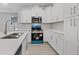 Modern kitchen with white cabinets, blue appliances, and quartz countertops at 200 W Kirby St, Tampa, FL 33604