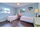 Bedroom with two twin beds, wood floors, and ample natural light at 2175 Nottingham Dr, Clearwater, FL 33764