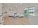 Bright living room with white sectional sofa and large window offering natural light at 2372 Millwood Ln, Clearwater, FL 33763