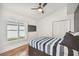 Spacious bedroom with hardwood floors, plantation shutters, and a ceiling fan at 276 Timberland Ct, Oldsmar, FL 34677