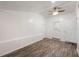 Bright room with wood-look floors, white walls, and a ceiling fan at 3612 Phillips St, Tampa, FL 33619