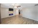 Living room with wood-look floors, electric fireplace, and ceiling fan at 3612 Phillips St, Tampa, FL 33619