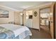 Bright bedroom with a king bed, dresser, and views into the living area and kitchen at 36750 Us Highway 19 N # 19219, Palm Harbor, FL 34684