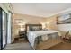 Spacious bedroom with a king-size bed, nightstands, and access to a balcony at 36750 Us Highway 19 N # 19219, Palm Harbor, FL 34684