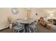 Round dining table with four chairs near living room at 36750 Us Highway 19 N # 19219, Palm Harbor, FL 34684