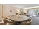 Round dining table with four chairs and living room view at 36750 Us Highway 19 N # 19219, Palm Harbor, FL 34684