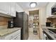Modern kitchen with granite countertops, stainless steel appliances, and ample cabinet space at 36750 Us Highway 19 N # 19219, Palm Harbor, FL 34684