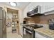 Kitchen boasts granite countertops, stainless steel appliances, and a sizable pantry at 36750 Us Highway 19 N # 19219, Palm Harbor, FL 34684